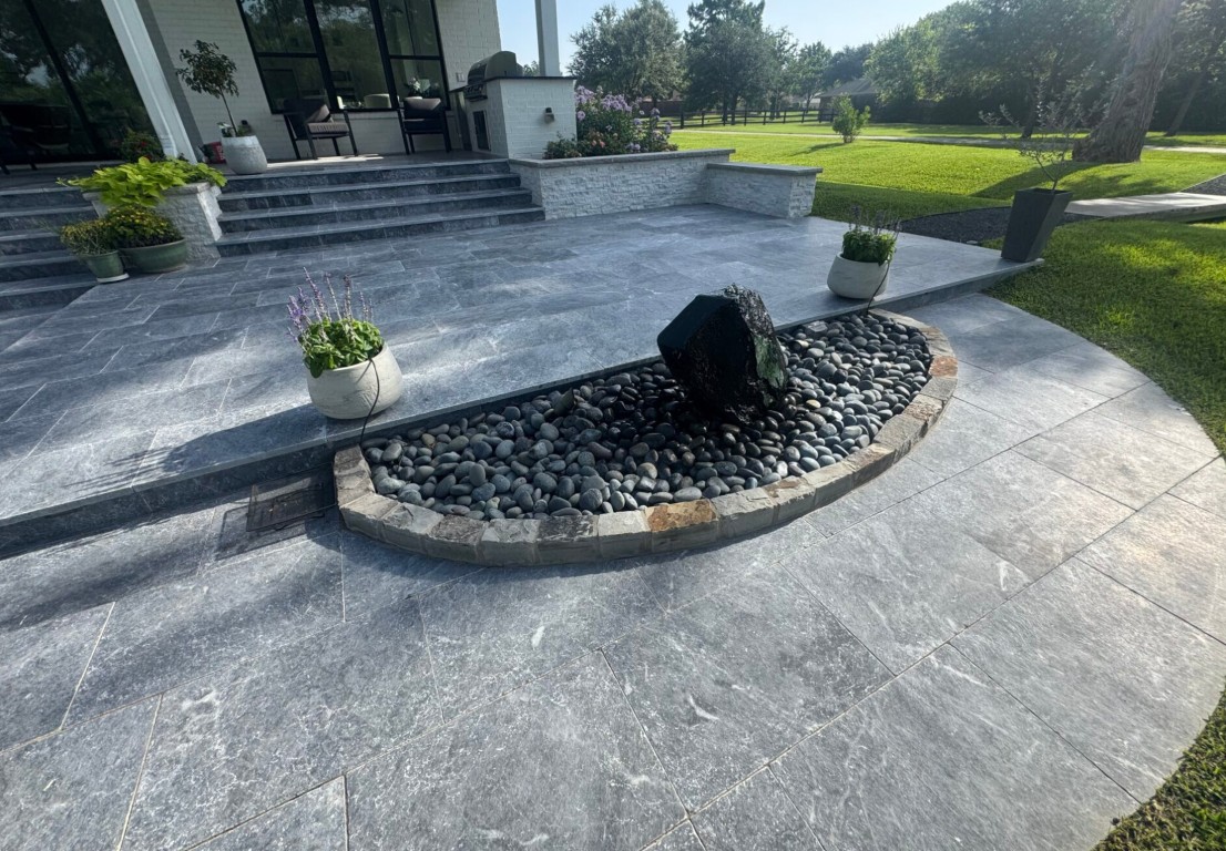 Beautiful stamped concrete patio with modern water feature